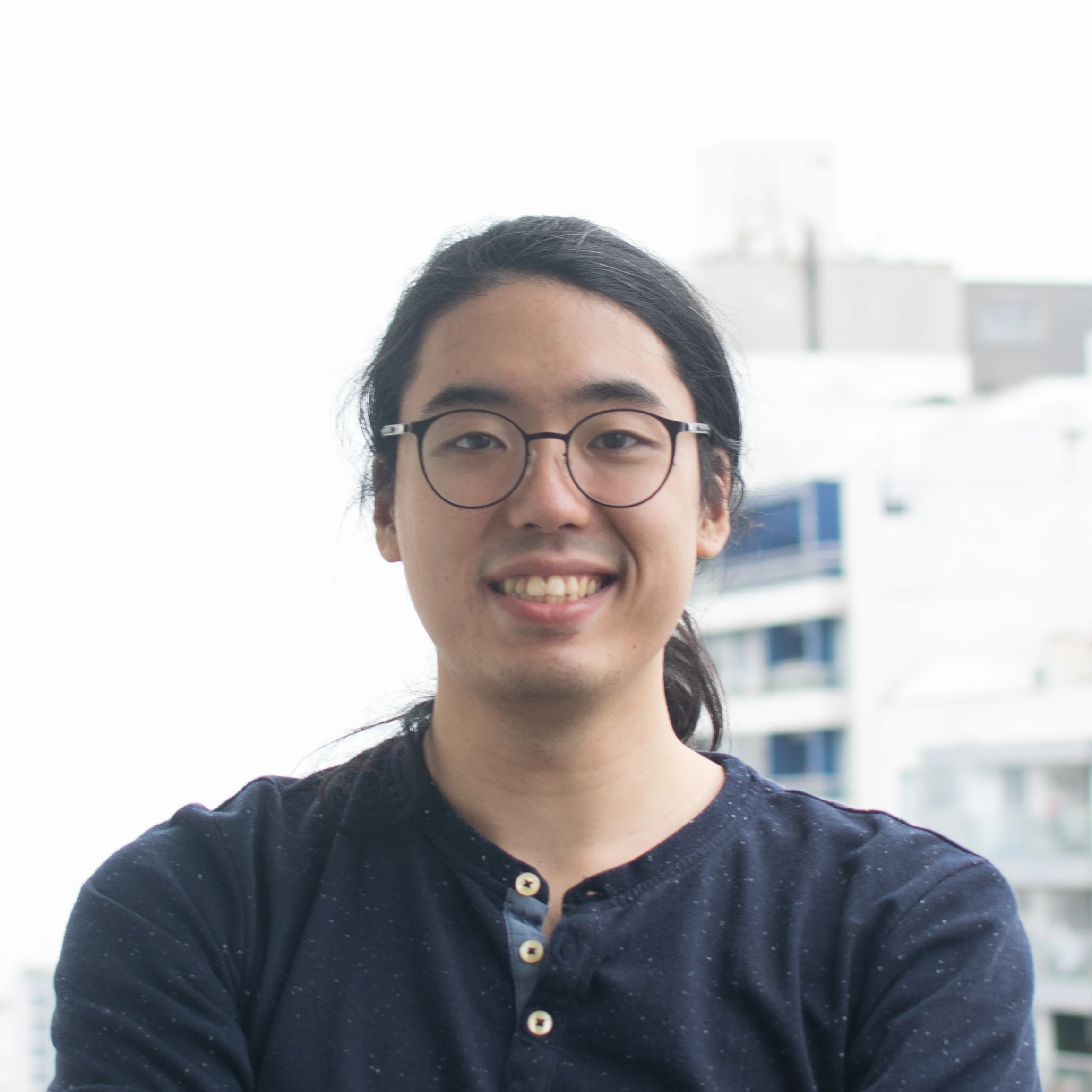 A professional headshot of Jorge Sakaino